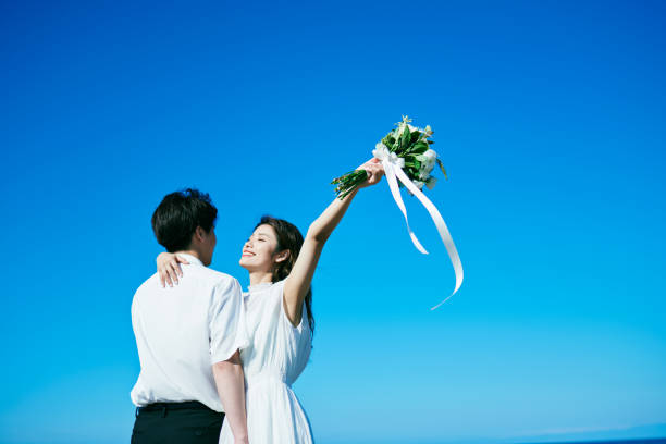 istock A wedding couple holding a bouquet 2190348917