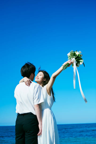 istock A wedding couple holding a bouquet 2190348945