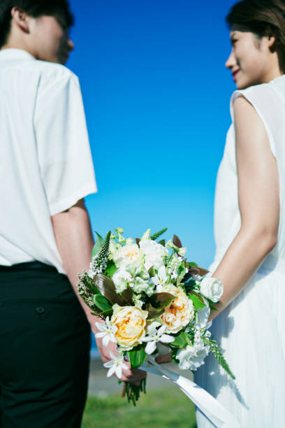 istock A wedding couple holding a bouquet 2190349406