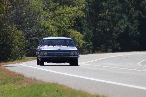 istock Classic car on a scenic forest road. 2190351525
