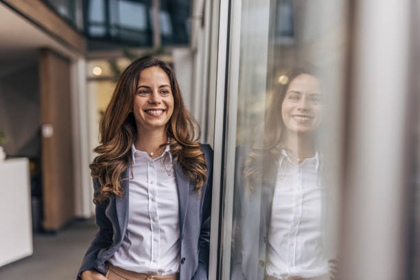 istock An attractive young businesswoman standing alone in her office 2190352106