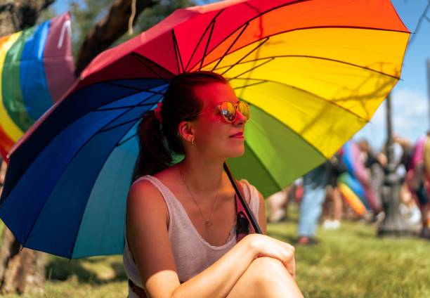 istock Woman with Rainbow Umbrella at Outdoor Event 2190353023
