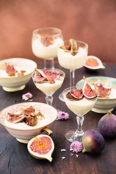 Glass bowls with white chocolate mousse topped with fig