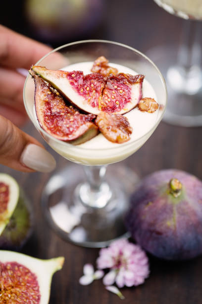 Glass bowl with white chocolate mousse topped with fig