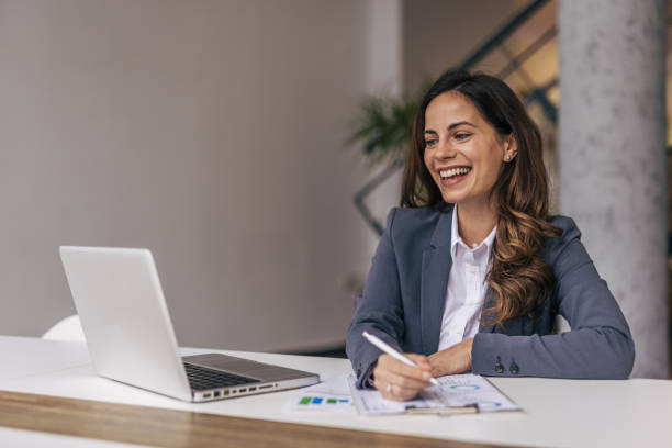 istock Successful businesswoman in modern office working on laptop 2190353970
