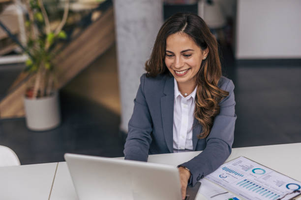 istock Successful businesswoman in modern office working on laptop 2190354183