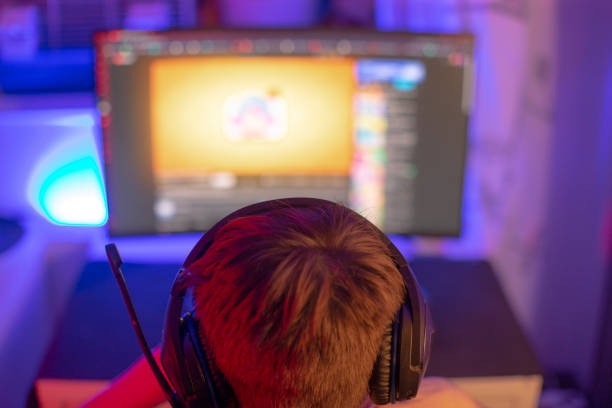 istock A boy in headphones is playing a video game on a computer 2190360468