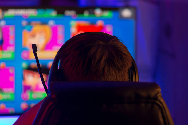 istock A man in headphones is focused on playing a video game 2190361000