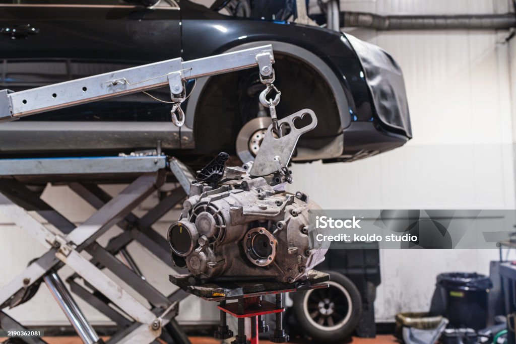 Engine Lifted Car Engine Being Repaired In A Garage Using A Crane Stock Photo ...