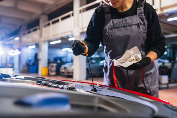 istock Mechanic checking oil level in car engine 2190362138