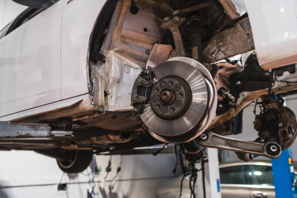 istock Car elevated on lift exposing brake disc and suspension 2190362791