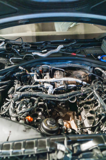 istock Car engine undergoing maintenance in repair shop 2190363446