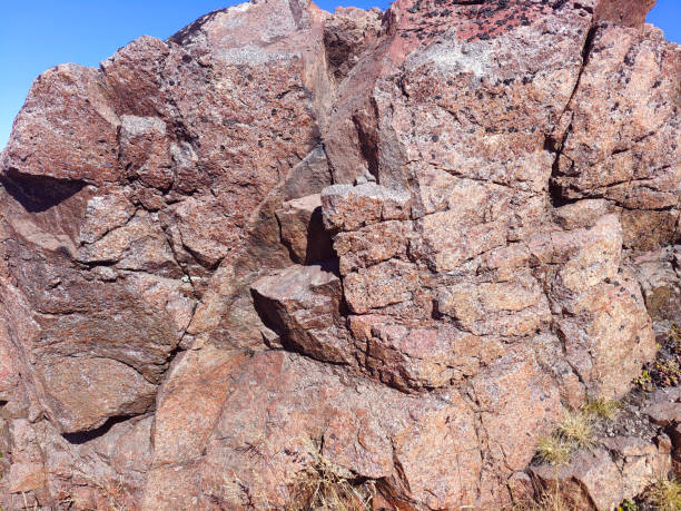 istock Wild red-brown rocks. Red granite in nature. Natural mineral background. 2190366015
