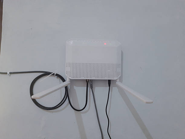 istock Wall-Mounted Wireless Router with Antennas in Minimalistic Home Setting 2190366445