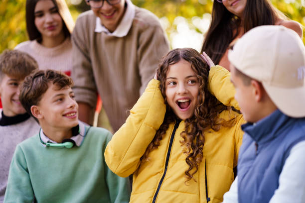 istock The children are talking about something exciting while sitting on the bench 2190366549
