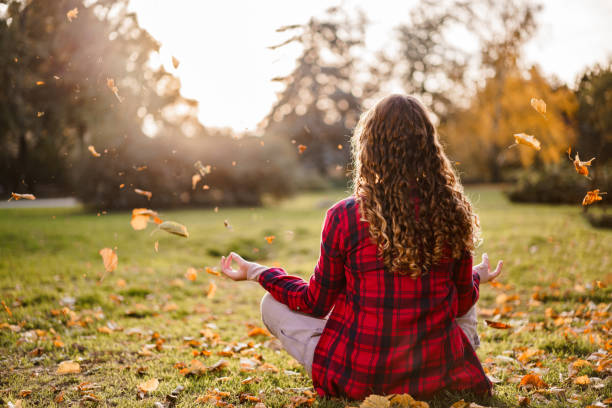 istock A girl meditates in an autumn park 2190368057