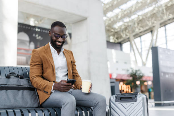istock Business traveler relaxing at a modern train station 2190368385