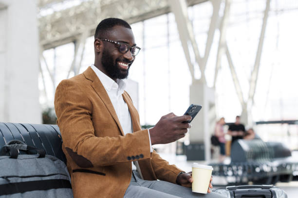 istock African American businessman smiling while using a  smart phone 2190368389