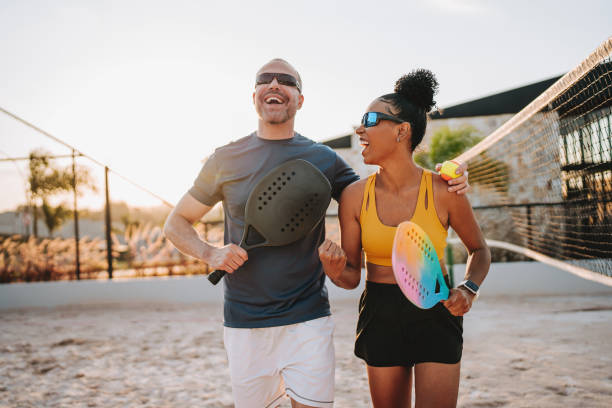 istock Couple celebrating winning beach tennis match 2190370324