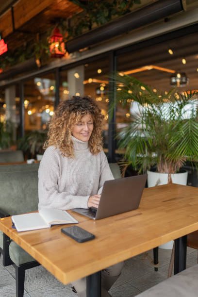 istock Happy businesswoman working at cafe 2190371730