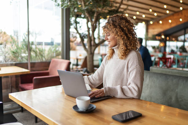 istock Happy businesswoman working at cafe 2190371837