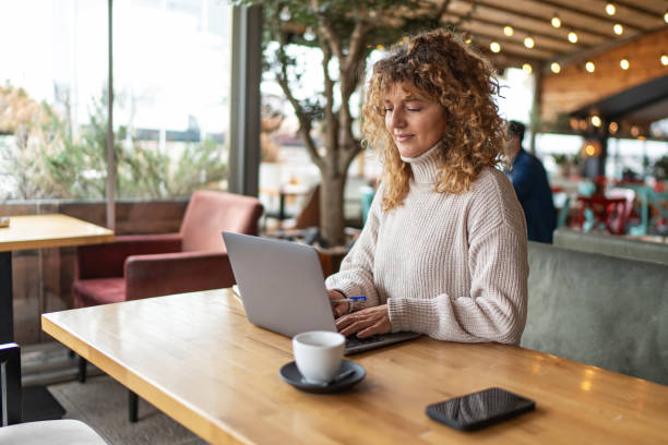 istock Happy businesswoman working at cafe 2190371881