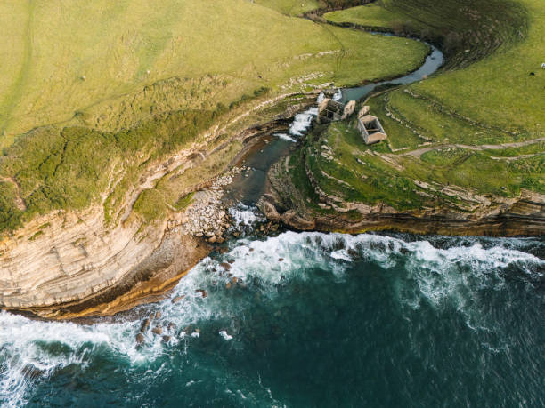 istock Abandoned mill with waterfall by the sea 2190372814