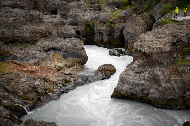 istock Tourists admiring hraunfossar and barnafoss waterfalls in iceland 2190373442
