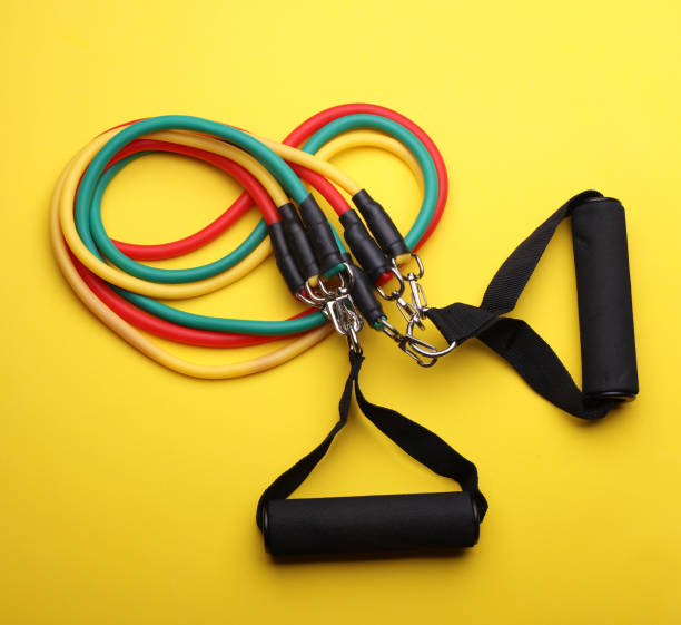 istock Rubber expander with handles for fitness on a yellow background 2190376918