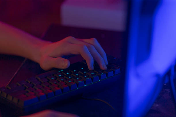 istock A person is intently typing on a computer keyboard in a dark room 2190377613