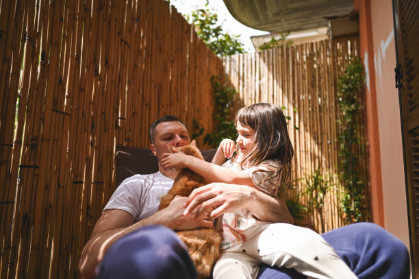 istock Family playing with ginger cat. 2190379000