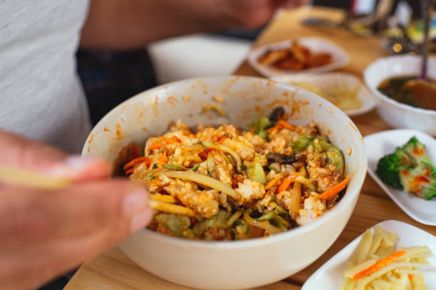 Man eating Bi Bim Bap in a restaurant