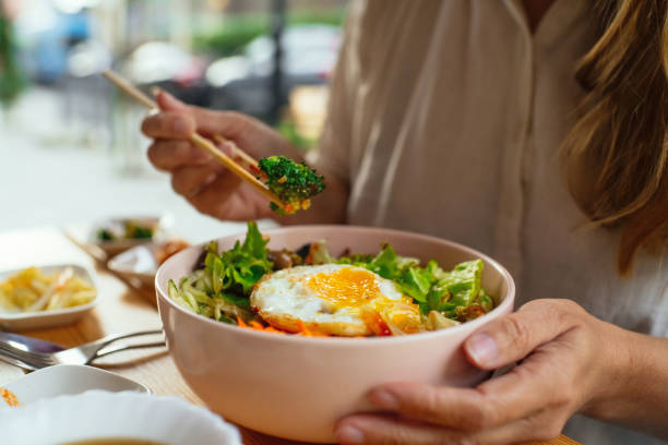 Woman eating Bi Bim Bap in a restaurant