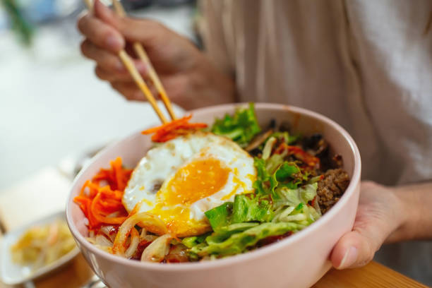 Woman eating Bi Bim Bap in a restaurant
