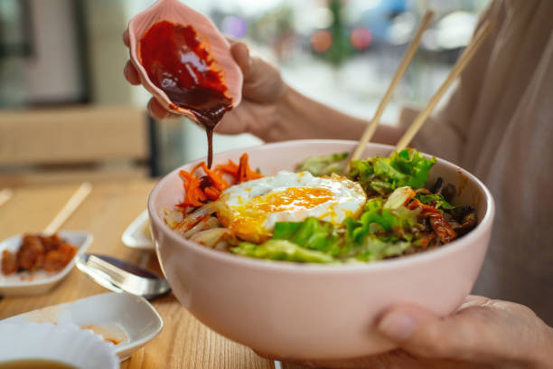 Woman eating Bi Bim Bap in a restaurant