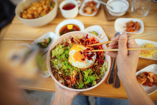 Woman eating Bi Bim Bap in a restaurant