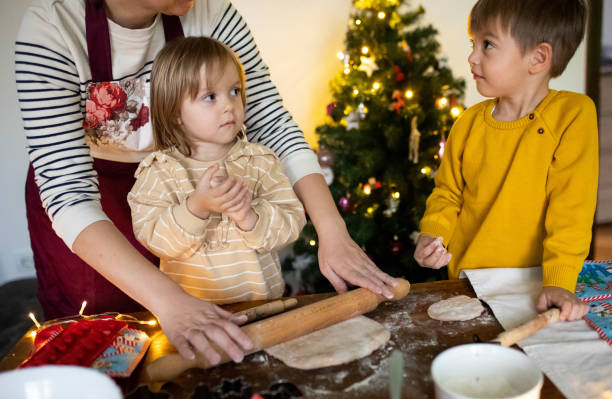 istock Creating holiday memories while children and their mom baking Christmas cookies 2190382485