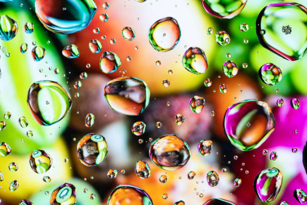 Splash of water drops on glass with colorful background.
