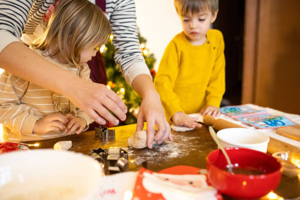 istock Creating holiday memories while children and their mom baking Christmas cookies 2190383816