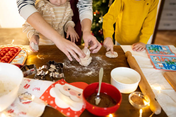 istock Creating holiday memories while children and their mom baking Christmas cookies 2190383820