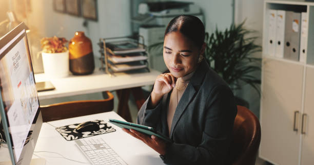 istock Thinking, research and woman with tablet, smile and working late for deadline, computer screen or online. Night, happy and positive results for campaign, media coordinator or browsing for competition 2190386143
