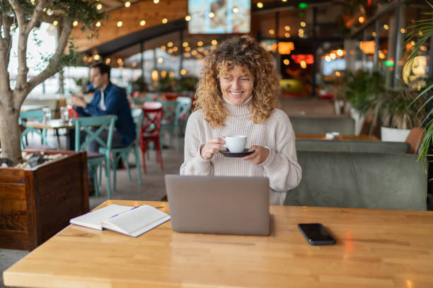 istock Young businesswoman drinking coffee in a cozy cafe 2190386165