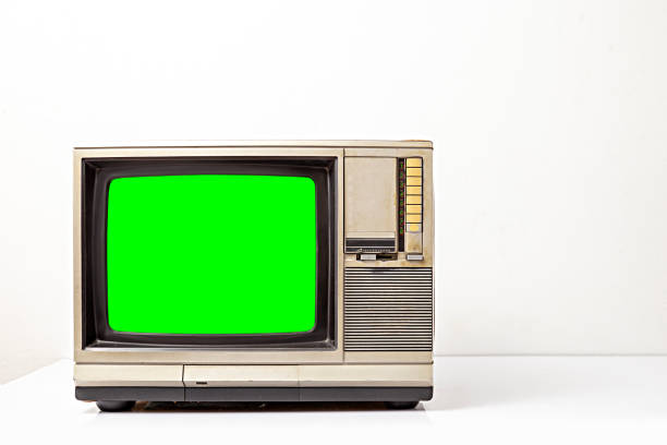 istock Old vintage television with cut out green screen. Retro old television on table over white background. Classic old obsolete TV with green screen. 2190386272
