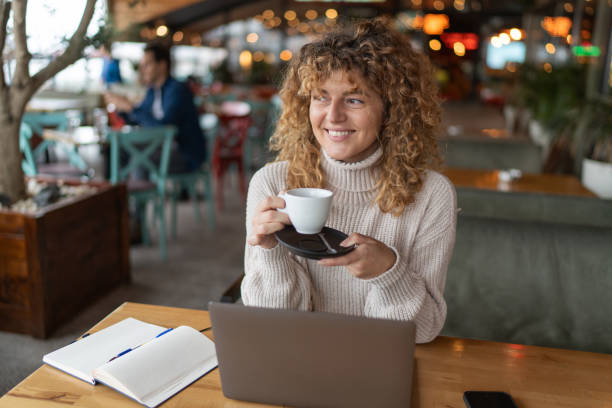 istock Young businesswoman drinking coffee in a cozy cafe 2190386425