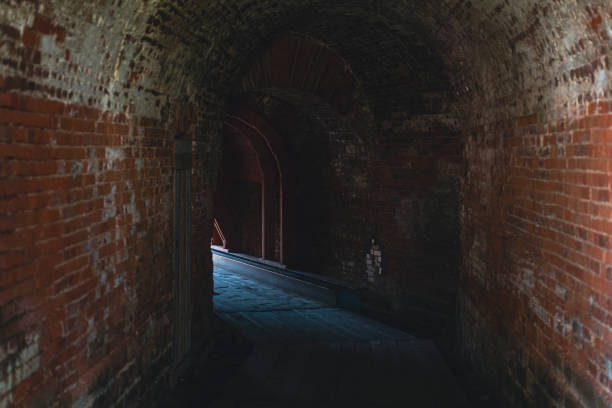 istock Dark brick tunnel in historic fortress with arched ceiling 2190389608