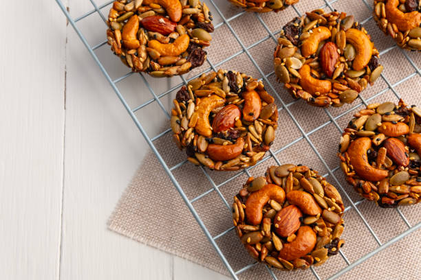 istock whole grain cookies no flour no sugar on Baking Cooling Rack.Mixed nuts, Almonds, Cashews, Peanuts, Raisins, sesame, sunflower, watermelon seed with honey cookie. 2190393637