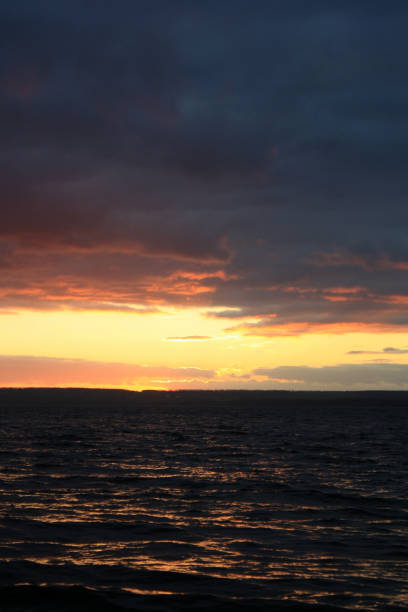 istock a sunset over a lake with a sunset in the background. 2190394217