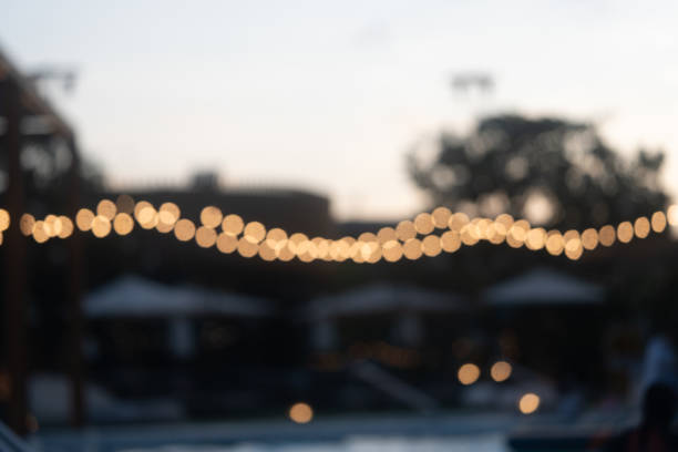 Defocused outdoor string lights hanging outdoor at the evening.