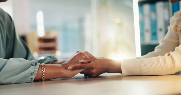 istock People, hands or empathy with consultation for talk, understanding or counseling therapy at office. Closeup, therapist or patient with touch for sympathy, emotion or support for grief, loss or advice 2190395781