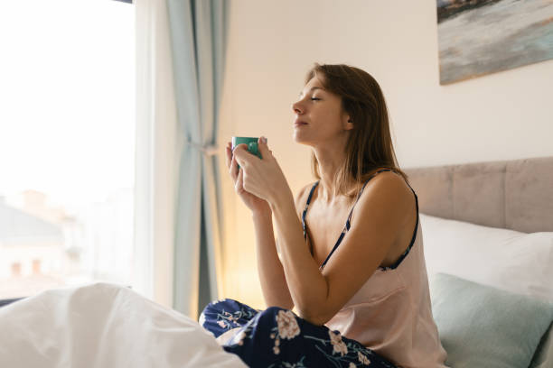 istock Woman having coffee in bed 2190396058